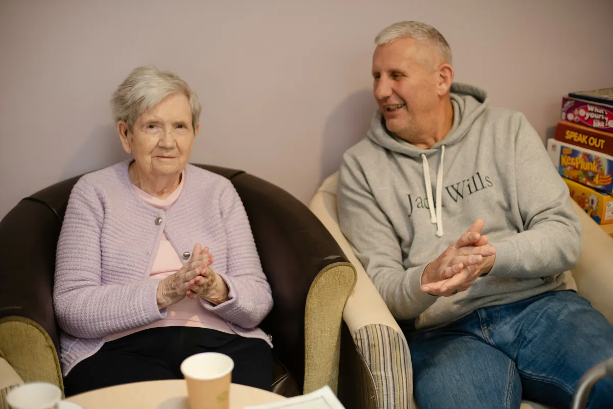 An older person and a family member completing the Attendance Allowance application form together.