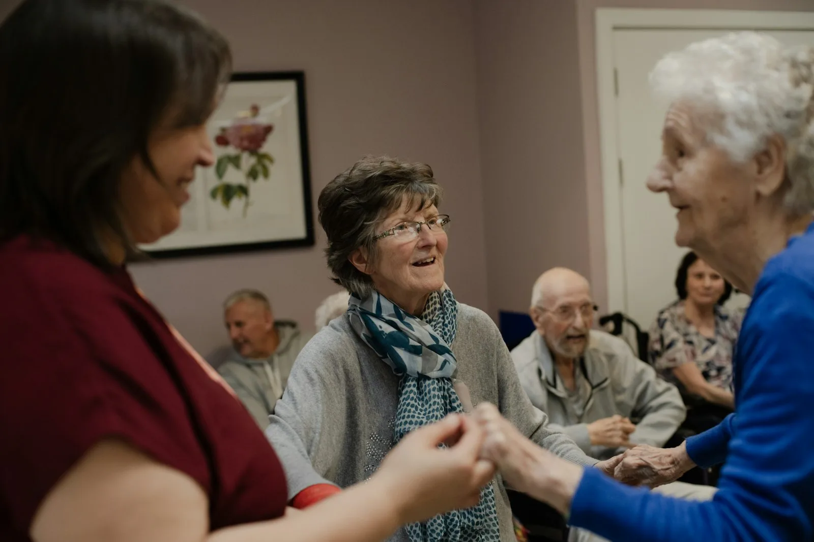 A care professional in conversation with an older woman in a supportive home setting — the moment of a Care Act needs assessment, the statutory gateway to council-funded social care in England under Sections 9, 10 and 17.