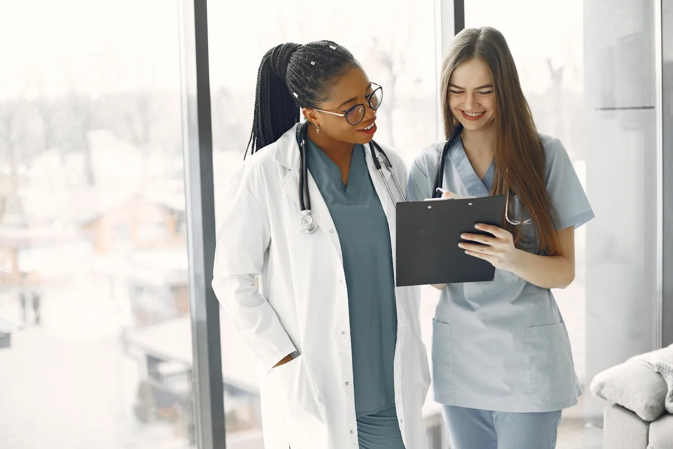 Two healthcare professionals reviewing assessment documents together — challenging a low CHC Checklist score means comparing each domain to the official descriptors and the evidence used.