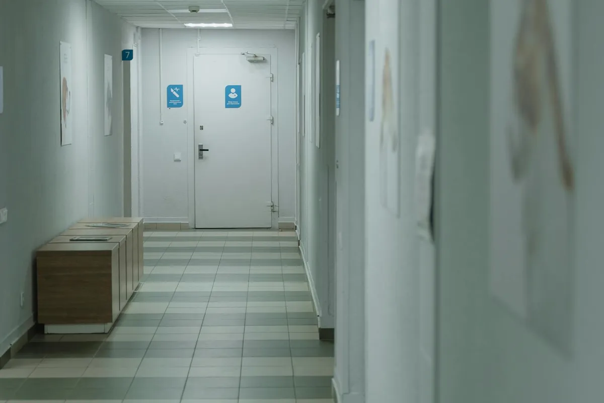 Quiet hospital corridor at dusk, representing the long appeal timelines families face in NHS Continuing Healthcare disputes.