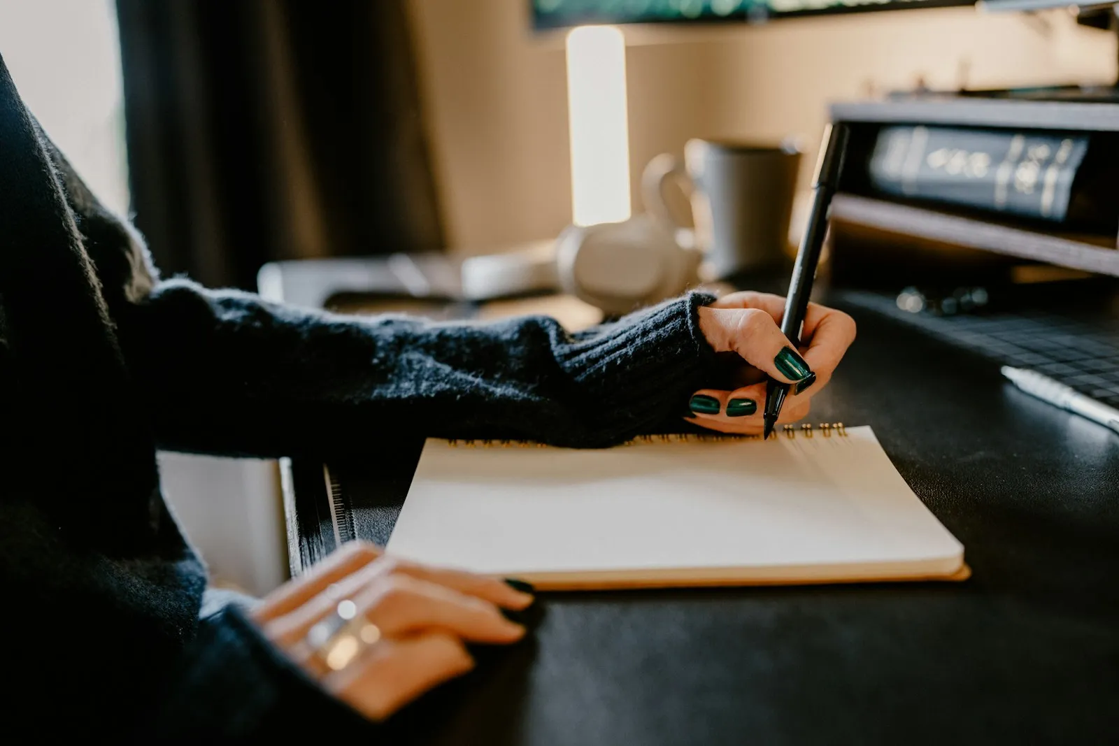 A family member sitting at a desk completing the COP1 deputyship application, with reading glasses, a calculator, and printed forms — the typical home setup for a DIY deputyship filing.