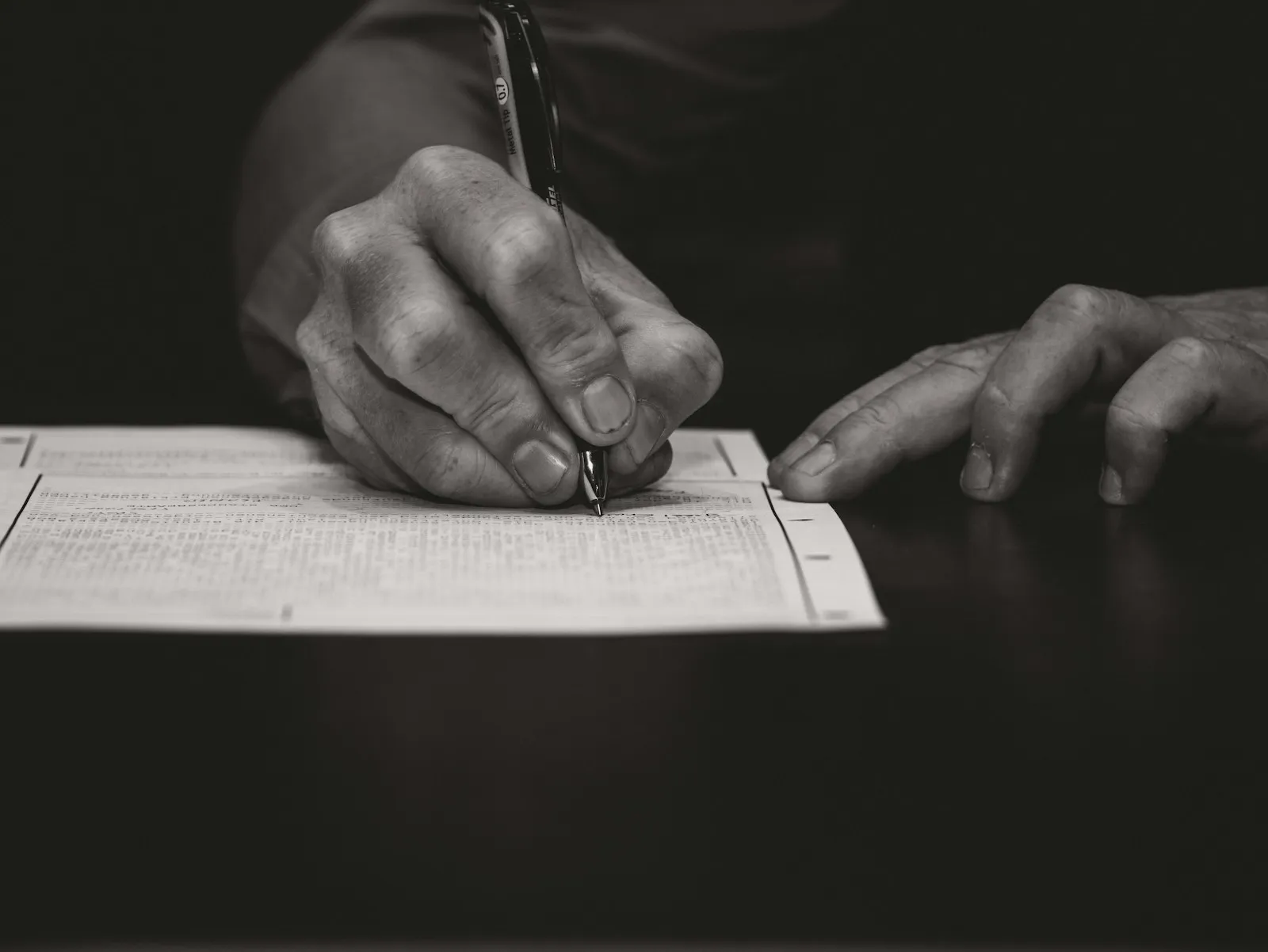 Legal papers and a folder of care home invoices on a desk, representing an executor bringing a retrospective NHS Continuing Healthcare claim on behalf of a deceased relative's estate.