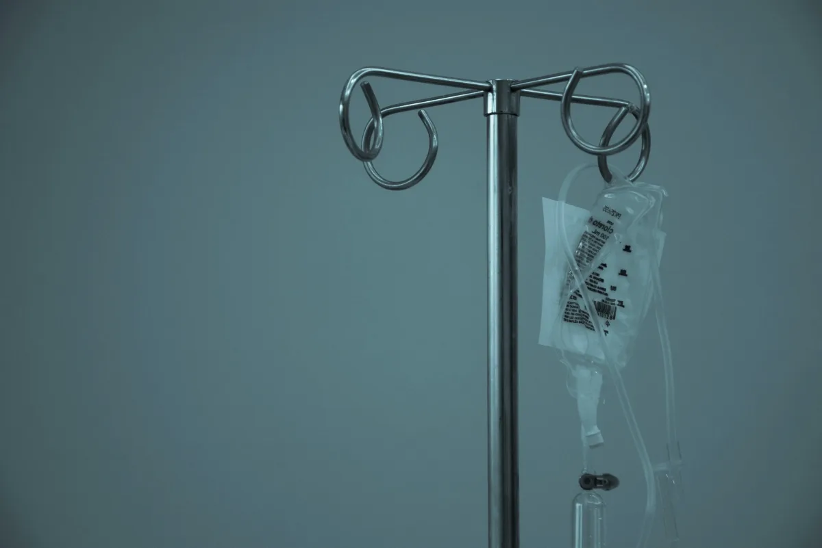 An adult child holding the hand of an elderly relative receiving end-of-life care at home — the moment Fast Track CHC funding can transform a family's options.