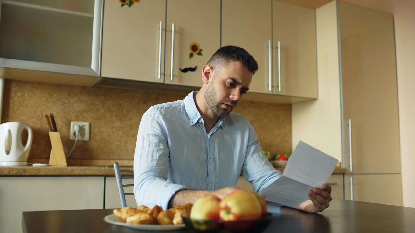 A person reviewing official NHS decision paperwork at a desk, representing a family preparing a continuing healthcare complaint to the Parliamentary and Health Service Ombudsman.