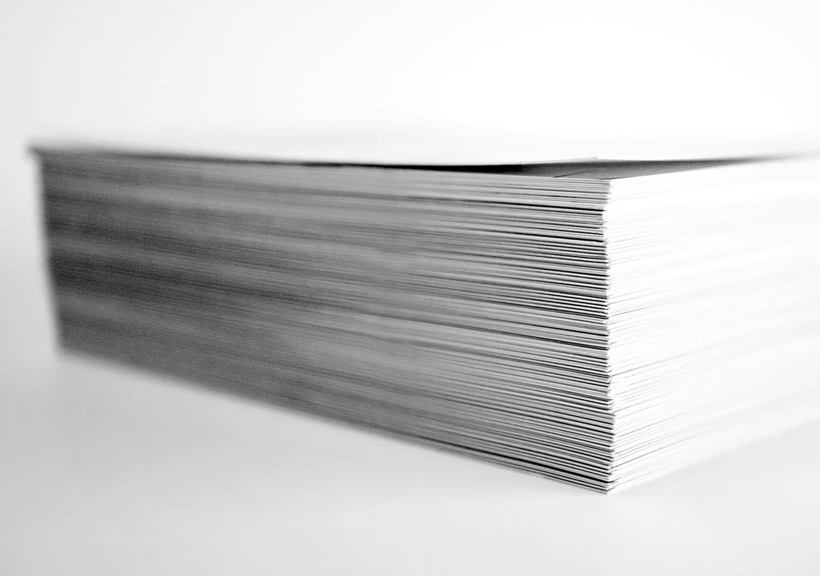A close-up of stacked manila medical records folders and a printed Subject Access Request letter on a wooden desk, representing the volume of documentation behind every NHS CHC case.