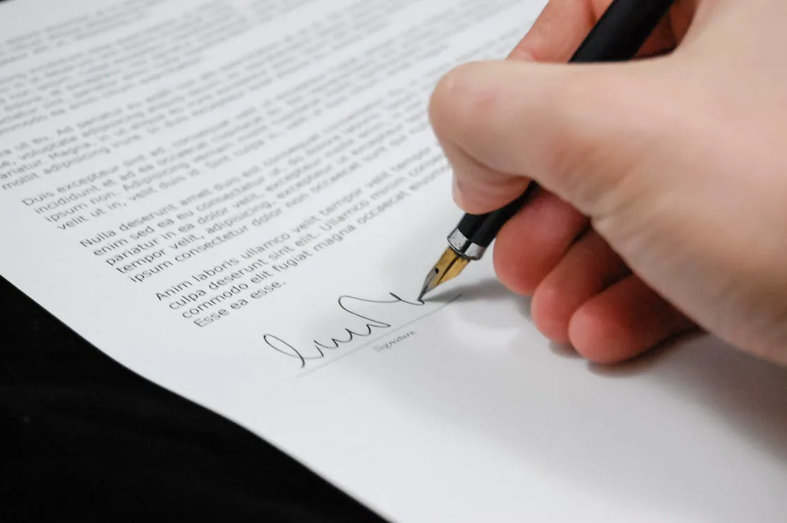 A person reviewing PIP and Universal Credit benefit paperwork at a kitchen table, representing the April 2026 welfare reform changes.