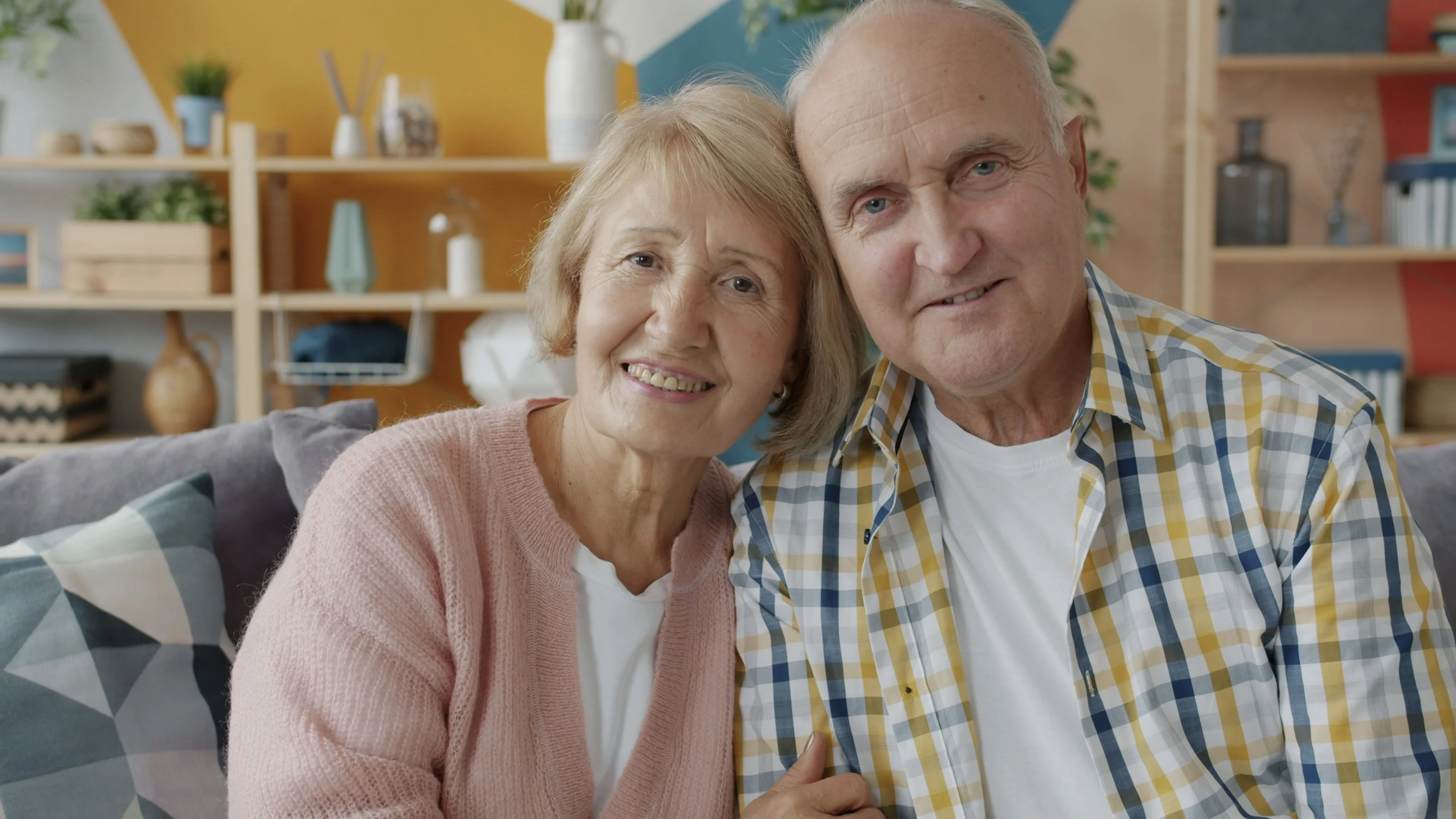 A married couple reviewing property deeds and care fee paperwork together, representing the tenants-in-common ownership approach to protecting a property share from care fees.