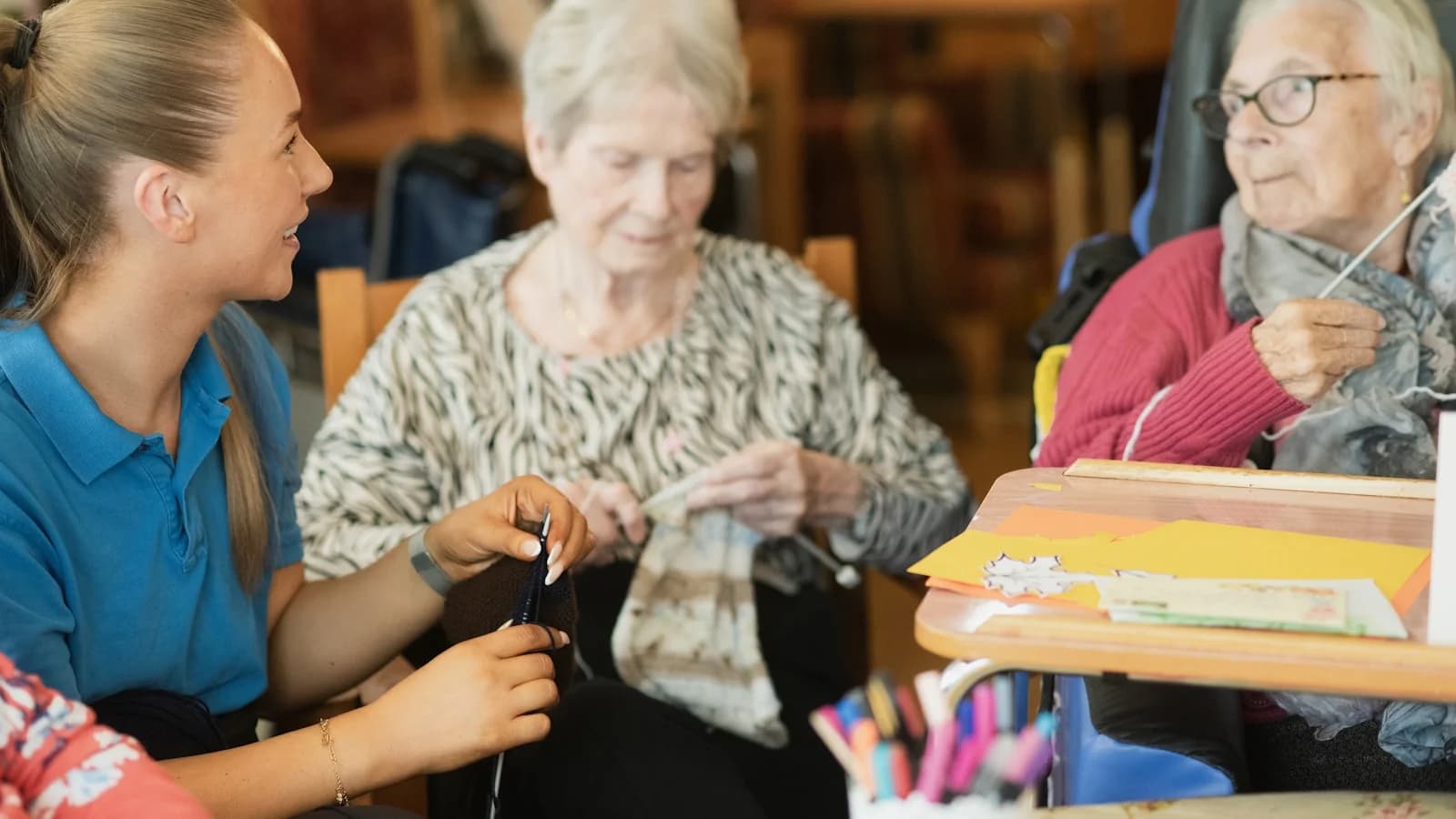 A caregiver supporting an older woman with a daily activity — a daily scene behind the question every family asks when they research who qualifies for NHS Continuing Healthcare funding.